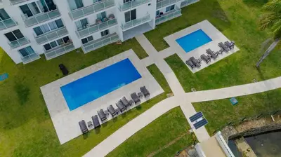 an aerial view of a building with two swimming pools at Work & Relax Studio Pools & Fast Wi-Fi in SOV in Sosúa