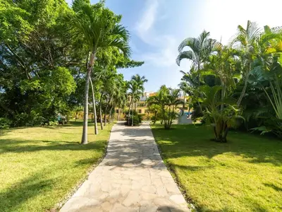 a path through a park with palm trees at Garden Condos APT 3 - Affordable 1BR APT in Sosua in Sosúa