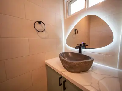 a bathroom with a bowl sink and a mirror at Garden Condos 5 - Ultra Modern Apartment in Sosua in Sosúa