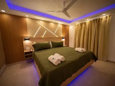 a bedroom with a bed with two towels on it at Garden Condos 5 - Ultra Modern Apartment in Sosua in Sosúa