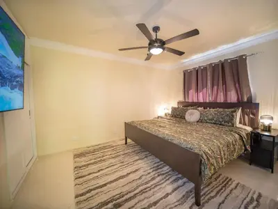 a bedroom with a bed with a ceiling fan at Garden Condos 21 Modern 1BR APT in Sosua Strip in Sosúa
