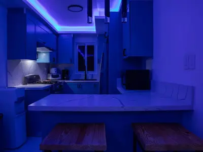 a blue kitchen with a large island in a kitchen at Garden Condos 39 Ultra modern apartment in Sosua in Sosúa