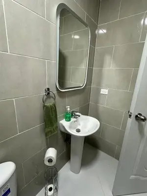 a bathroom with a sink and a mirror at Maravilla Bayahibe , Stylish Apartment, Pool a Wifi in Bayahibe