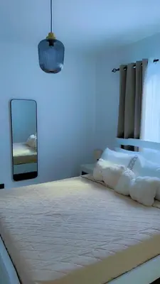 a bedroom with a large bed with a mirror at Appartement lumineux, piscine & plage proche in Punta Cana