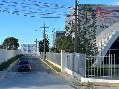 a car parked on a street next to a fence at Appartement lumineux, piscine & plage proche in Punta Cana