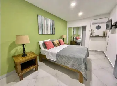 a bedroom with a bed and a table with a lamp at 10 bedroom huge villa close to Sosua downtown in Sosúa