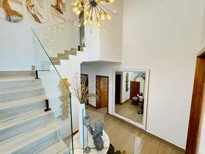 a living room with a staircase and a mirror at Luxury Villa in Punta Cana in Punta Cana