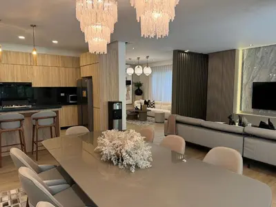 a dining room and living room with a table and chairs at Luxury Villa in Punta Cana in Punta Cana