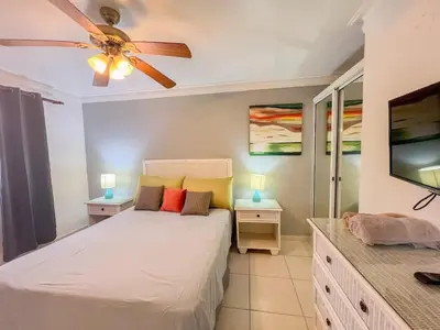 a bedroom with a bed and a ceiling fan at Garden Condos APT 44 - Comfy 1BR APT in Sosua in Sosúa