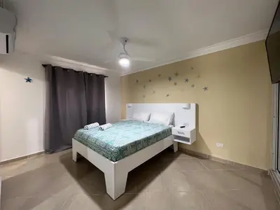 a bedroom with a bed with stars on the wall at Garden Condos 48 - Friendly 1BR APT Sosua Center in Sosúa