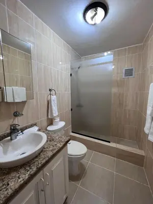 a bathroom with a toilet and a sink and a shower at Garden Condos 48 - Friendly 1BR APT Sosua Center in Sosúa