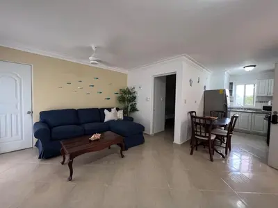a living room with a blue couch and a table at Garden Condos 48 - Friendly 1BR APT Sosua Center in Sosúa