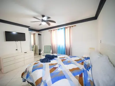 a bedroom with a bed and a ceiling fan at Garden Condos 7 - Central Apartment in Strip in Sosúa