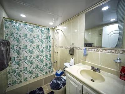 a bathroom with a sink and a shower curtain at Garden Condos 7 - Central Apartment in Strip in Sosúa