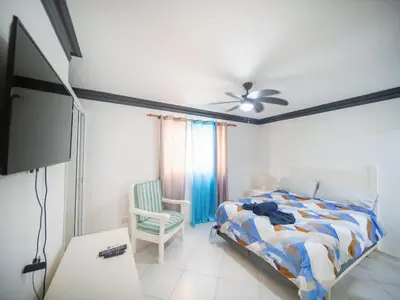a bedroom with a bed and a ceiling fan at Garden Condos 7 - Central Apartment in Strip in Sosúa
