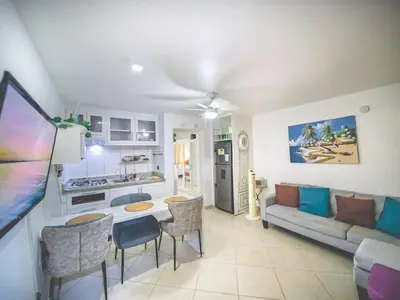 a kitchen and living room with a couch and a table at Central 1BR APT - 1 minute Walking from Rumba in Sosúa