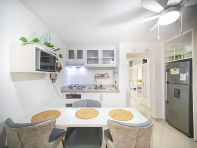 a kitchen with a table and chairs and a refrigerator at Central 1BR APT - 1 minute Walking from Rumba in Sosúa
