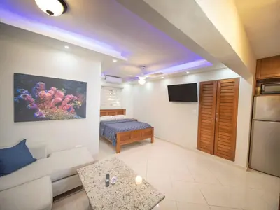 a living room with a couch and a bed at Casa de Compai Studio 2 Walk to Beach & Fun in Sosúa