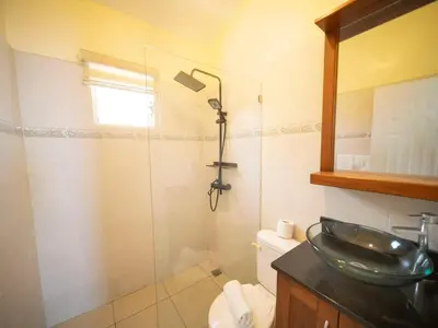a bathroom with a sink and a glass shower at CC 3 Casa de Compai Unit 3 Steps to Everything in Sosúa