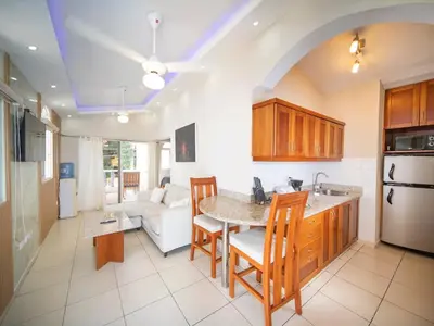 a kitchen and living room with a table and chairs at CC 3 Casa de Compai Unit 3 Steps to Everything in Sosúa