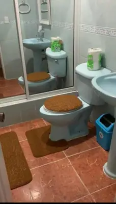a bathroom with two toilets and a sink at gina apartamento in Monte Llano