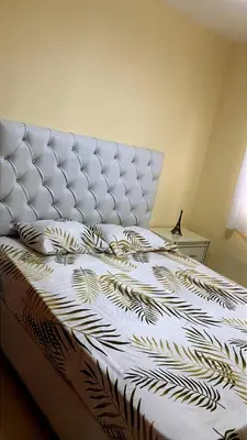 a bedroom with a bed with a black and white comforter at Comfortable Apartament 20 Minutes from the airport in San Isidro