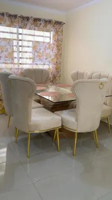 a dining room with a glass table and chairs at Comfortable Apartament 20 Minutes from the airport in San Isidro