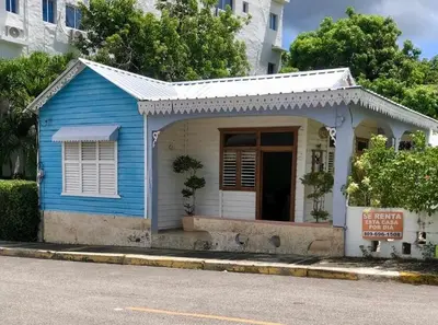 a blue and white building on the side of a street at Exclusive Beachside House with Private Backyard in Río San Juan