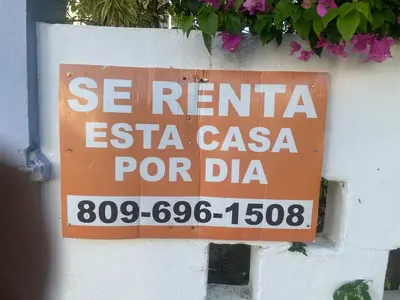 a sign on the side of a wall at Exclusive Beachside House with Private Backyard in Río San Juan