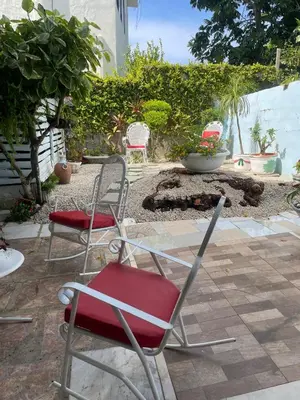 a group of chairs sitting on a patio at Exclusive Beachside House with Private Backyard in Río San Juan
