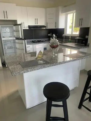 a kitchen with a counter and a black stool at 2 Bdrm, 1 Bath, Wifi, Near River and Beach,4L in Paraíso