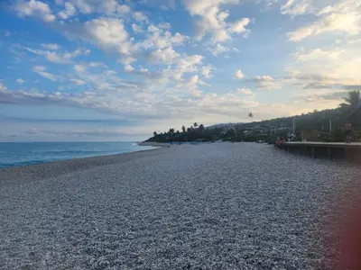 a rocky beach with a cloudy sky and the ocean at 2 Bdrm, 1 Bath, Wifi, Near River and Beach, 2L in Paraíso