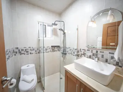 a bathroom with a toilet and a sink and a shower at Casa de Compai Unit 4 Comfort in Central Sosua in Sosúa