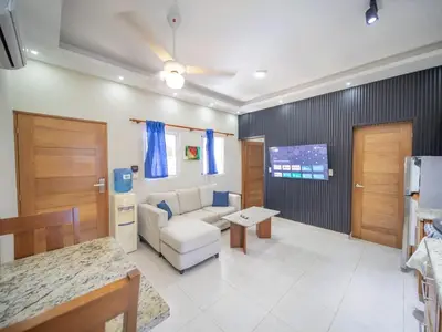 a living room with a couch and a table at Casa de Compai Unit 4 Comfort in Central Sosua in Sosúa