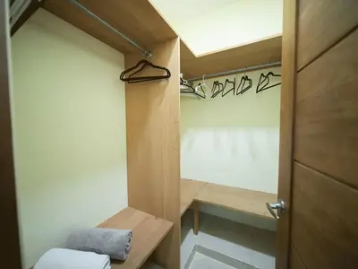 a bathroom with a door and a towel on a bench at Casa de Compai Unit 4 Comfort in Central Sosua in Sosúa