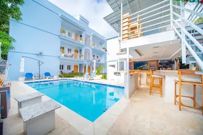 a swimming pool in the middle of a house at 1BR Apt with Pool & Cigar Bar Lounge Casa de Compai in Sosúa