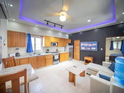 a kitchen and living room with a couch and a table at CC 7 Casa de Compai Unit 7 AC WiFi Prime Location in Sosúa