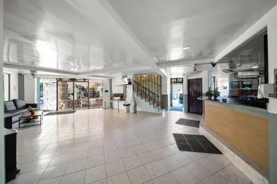 a large room with a tile floor and a hallway at Centric Studio in Sosua Center Pool & Workspace in Sosúa