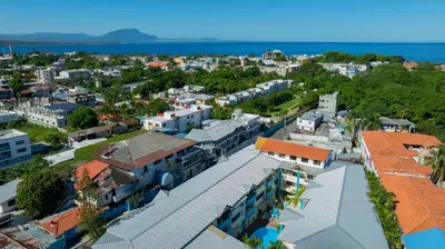 an aerial view of a city with buildings and the ocean at Centric Studio in Sosua Center Pool & Workspace in Sosúa