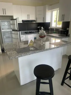 a kitchen with a counter and a black stool at 2 Bdrm, 1 Bath, Wifi, Near River and Beach, 2R in Paraíso
