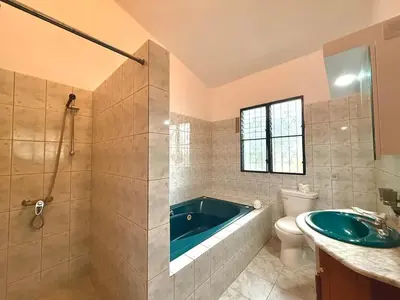 a bathroom with a tub and a toilet and a sink at 2 Bedroom Villa with private Pool in Sosua in Sosúa