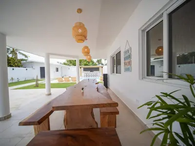 a wooden bench in the middle of a room at Green Palace 7 Bedroom Villa in Sosua with Security in Sosúa