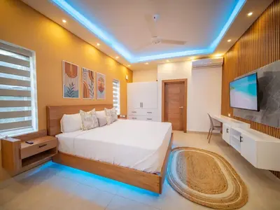 a bedroom with a bed and a desk and a tv at Green Palace 7 Bedroom Villa in Sosua with Security in Sosúa