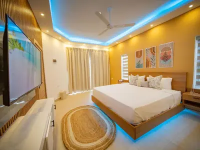 a bedroom with a large bed and a flat screen tv at Green Palace 7 Bedroom Villa in Sosua with Security in Sosúa