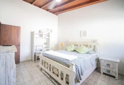 a bedroom with a bed in a white room at HUGE Balcony APT next to HARD ROCK CAFE and Beach in Sosúa