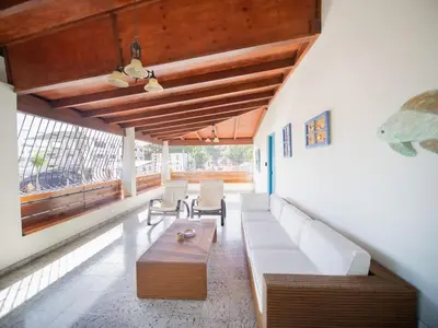 a living room with a couch and a table at HUGE Balcony APT next to HARD ROCK CAFE and Beach in Sosúa