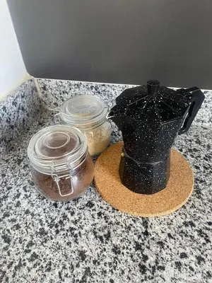 a black vase and two jars on a counter at 2 Bdrm 1 Bath Near River and Beach, 3L, Paraíso, Barahona in Paraíso