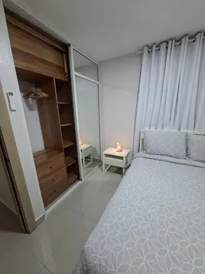 a small bedroom with a bed and a night stand at Apartment in Santo Domingo in El Caliche