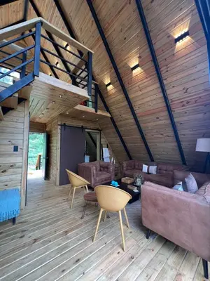 a living room with a couch and a loft at Alpina Village, Jarabacoa in Jarabacoa