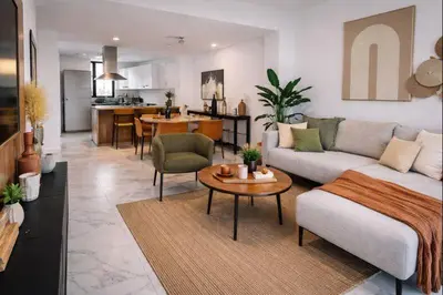 a living room with a couch and a table at Aqua Poolside Serenity Pool & Golf 2B Cana Bay in Punta Cana